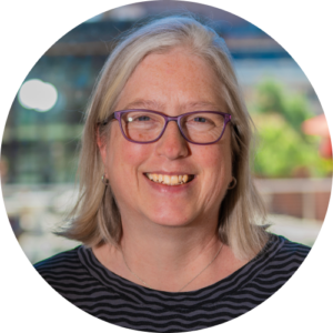 Headshot of Maggie Christ, Executive Director of Ballet Tech, smiling.